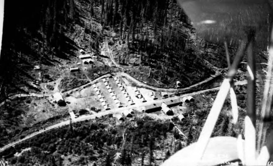 Aerial photograph of CCC Camp Lower Beaver, F-147, and surrounding areas. Parts of the plane can be in the foreground.