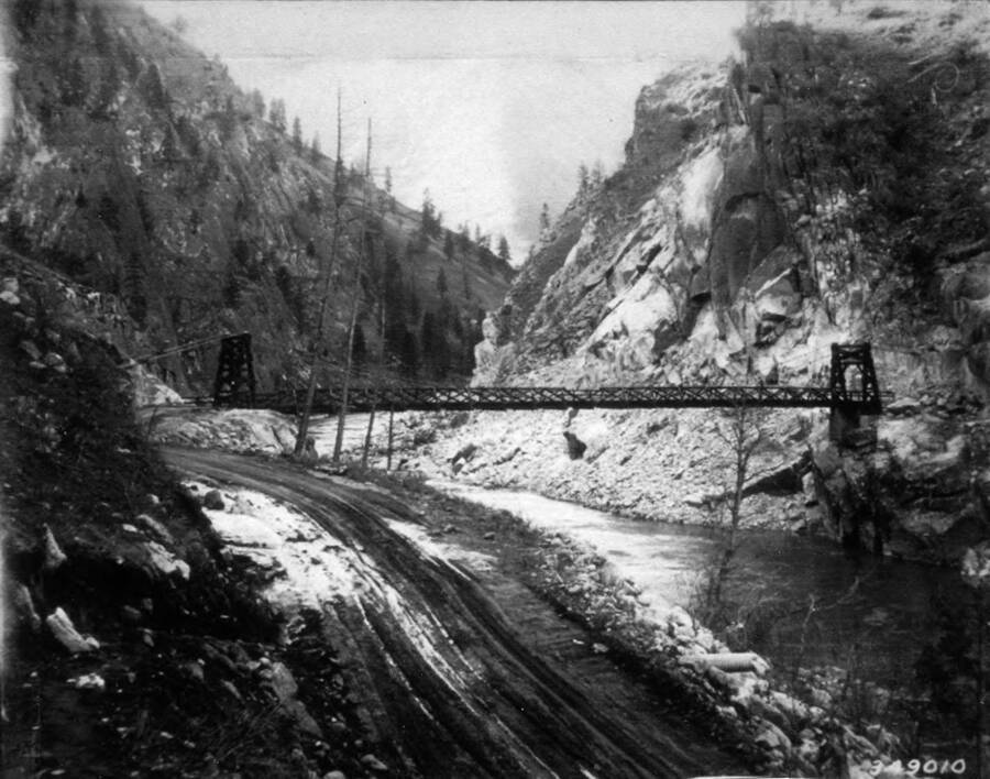 Photo of the Manning Bridge, spanning the Salmon River. Writing around the photo reads: 'The Manning Bridge Constructed by the CCC'.