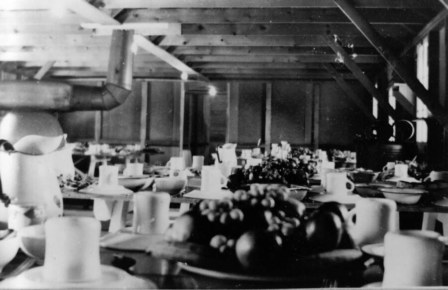 The Dining Hall decorated for Thanksgiving dinner at CCC Camp S-223. Writing underneath the photo reads: '1850.0020. Thanksgiving dinner in Mess Hall, S-223, McCall, 1935'.