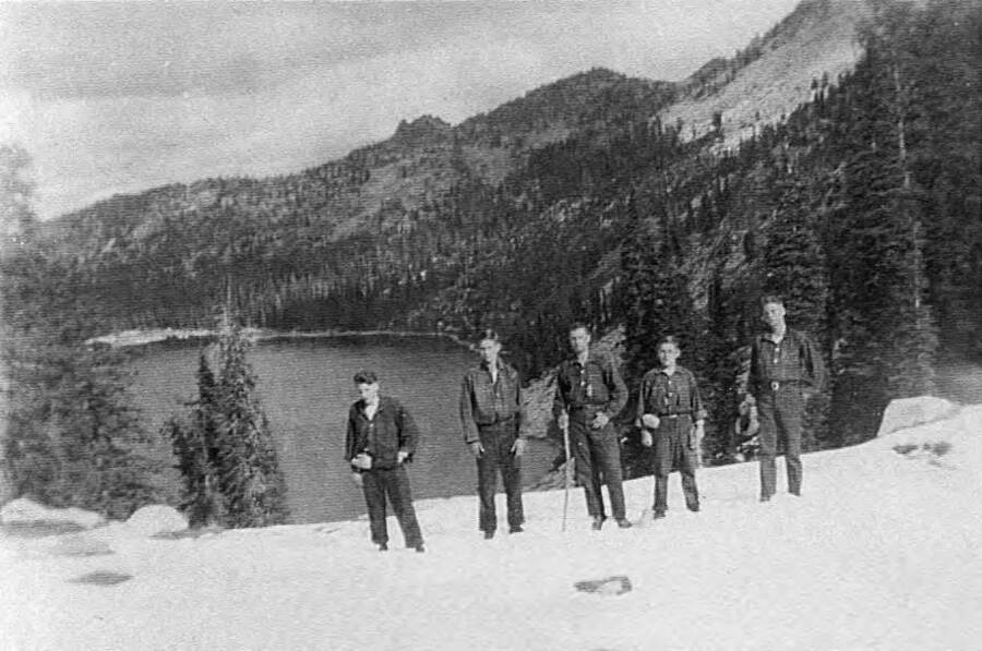 Five people stand above Box Lake. Writing beneath the photo reads 'Photo No. 1850.0049. Camp French Creek, 1939'