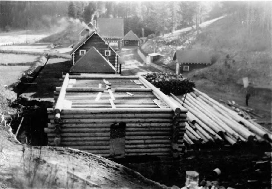 Construction of the new recreation hall and general camp is underway at Smiths Ferry Spike Camp. Writing beneath the photo reads: 'Photo No. 1850.0076. New recreation hall and general camp, Smiths Ferry Spke Camp, C-1997 (?).'