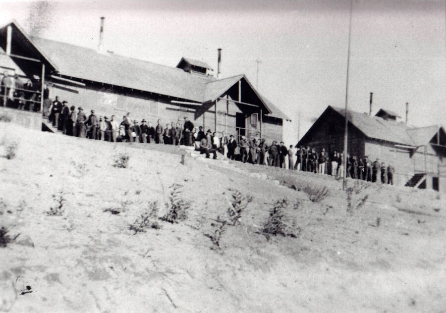 Men from CCC Company 1994 standing in line for payday at Camp Kalispell Bay, F-142 at Priest Lake, Idaho.