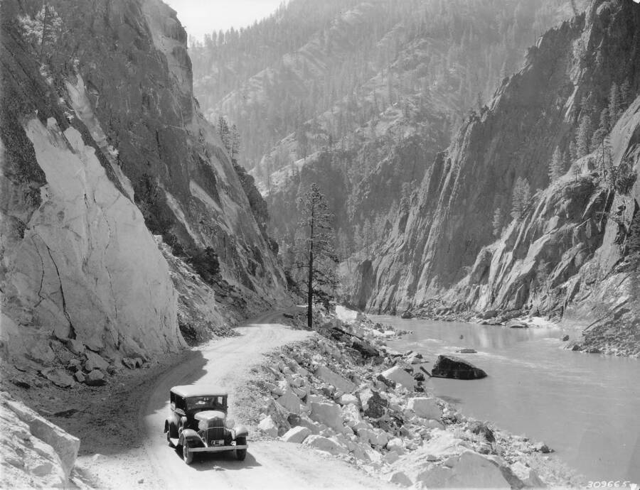 A photograph of Salmon River Road at the 'crevice', after it was built by the CCC. The back of the photograph reads: 'Salmon River Road built by the CCC's, at the 'Crevice,' Nezperce National Forest'