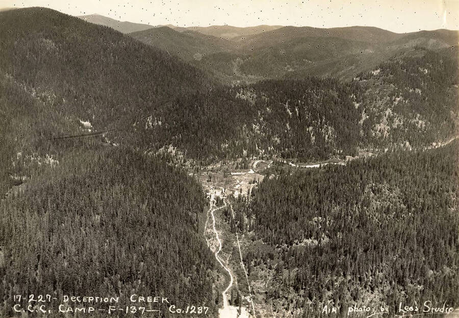 Aerial view of Deception Creek and the CCC Camp there. Writing on the photo reads: '17-227 Deception Creek CCC Camp F-137 Company 1237 Air photo by Leo's Studio'.