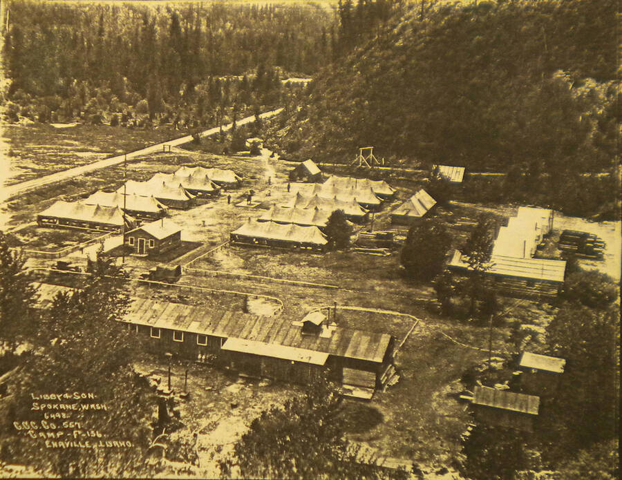 View of Camp Enaville from above. Buildings and tents can be seen around the camp.