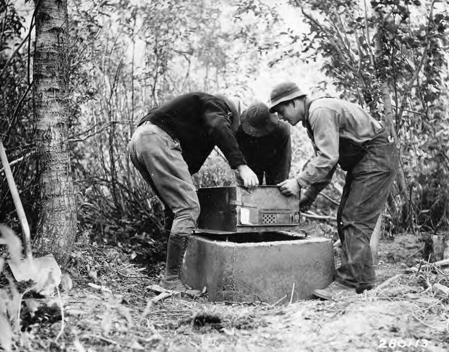 Three men installing campground stoves at Wood River Campground, Camp Ketchum, in the Sawtooth National Forest, Idaho.