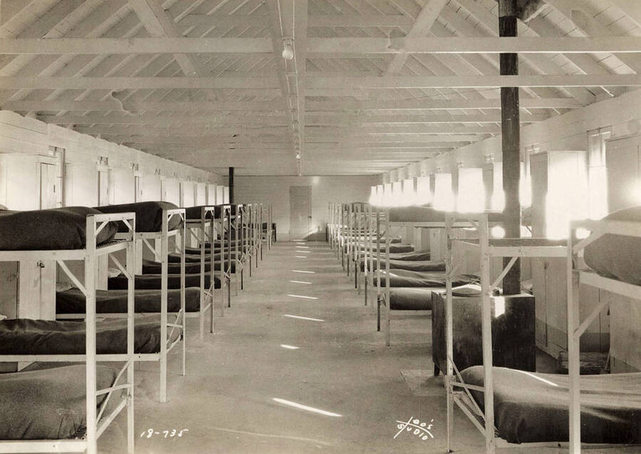 Interior view of the Cataldo CCC Camp barracks. The bunks are steel and have springs and the interior of the bunkhouse is painted. The bunk houses at the Cataldo Camp are the finest-equipped in the district.