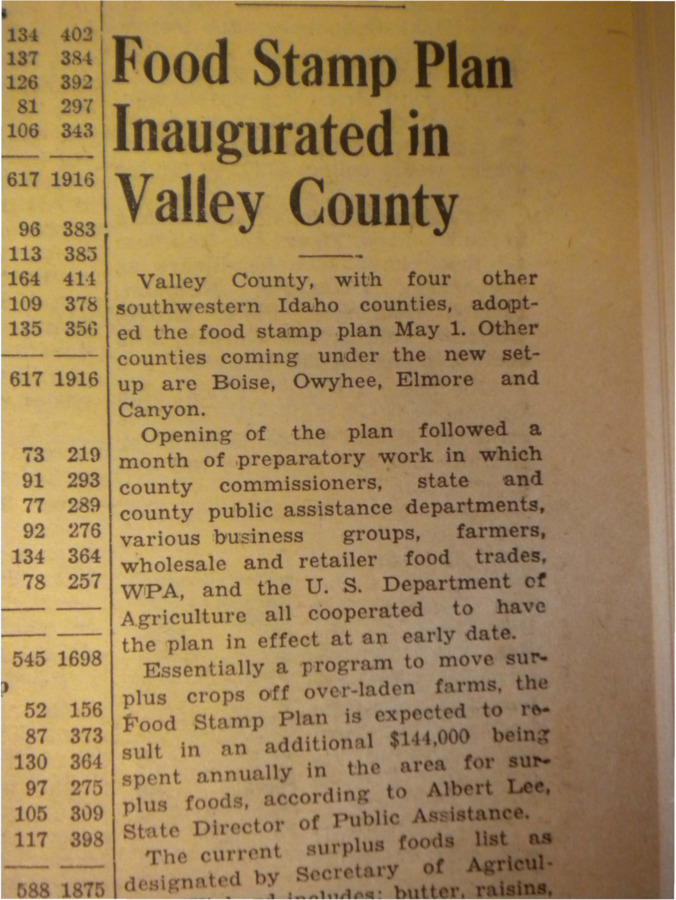 Story about the adoption of the food stamp plan, a program intended to move surplus crops off over-laden farms, by Valley County.