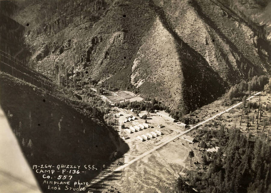 Aerial view of Grizzly CCC Camp, F-136. Writing on the photo reads: '17-264 Grizzly CCC Camp F-136 Company 557 Airplane photo by Leo's Studio'.