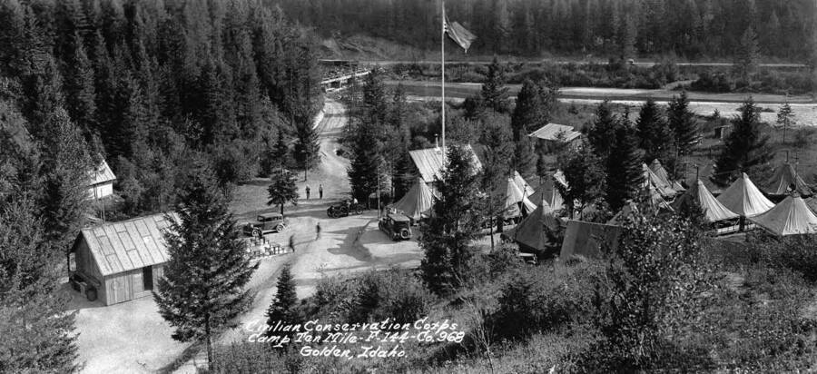 A birds-eye view of Camp Ten Mile, F-144, Company 968. Near Golden, Idaho, on the South Fork of the Clearwater River. The writing on the photo reads: 'Civilian Conservation Corps Camp Ten Mile F-144 Co. 968 Golden, Idaho.'