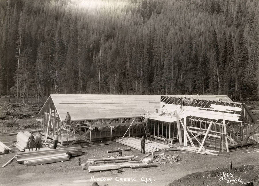 Workers constructing a building at the Hudlow Creek CCC Camp. Writing on the photo reads: 'Hudlow Creek CCC Leo's Studio'.