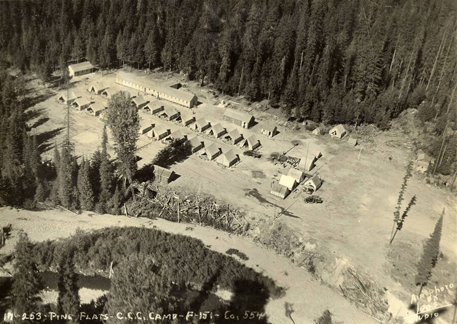 Aerial view of Pine Flats CCC Camp. Writing on photo reads: 'Pine Flats CCC Camp F-151 Company 554 Air photo by Leo's Studio'. Back of photo reads: 'Pine Flats CCC Camp. Wallace District. 1935'.