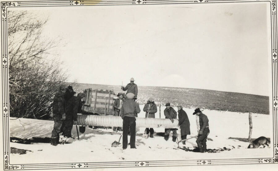 Work crew in snow, laying culvert, Ft. Hall