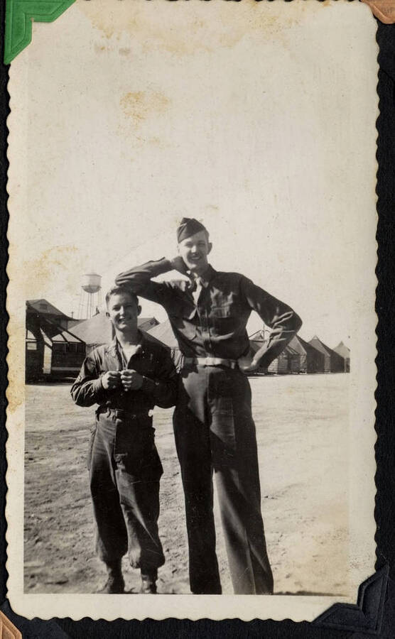 Tall and short enrollees posing side-by-side. SCS-01, C-1503. From the Paul Saft photographic album, SCS-1, C-1503, 1938-39, depicting camp life, taken mostly in the Moscow, Lewiston, Robinson Lake areas.