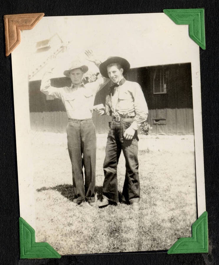 Two men in western hats posing as a hold-up, SCS-1, C-1503. From the Paul Saft photographic album, SCS-1, C-1503, 1938-39, depicting camp life, taken mostly in the Moscow, Lewiston, Robinson Lake areas.