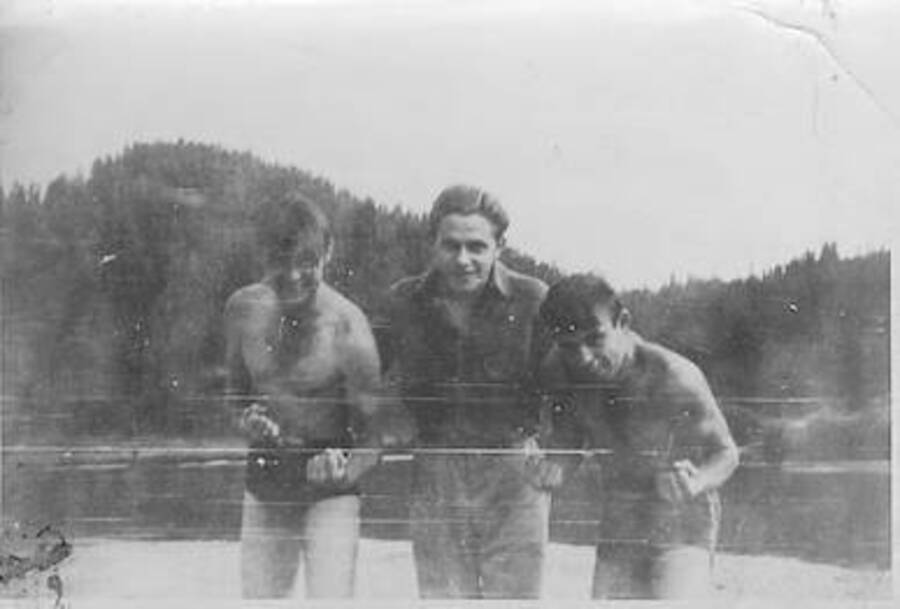 Boxers and referee, Cougar Mountain and Payette River in background. Identification l-r: unknown, John Rais, Wally Wallingford (from Norwood/Cincinnati). Smith Ferry, 1939.