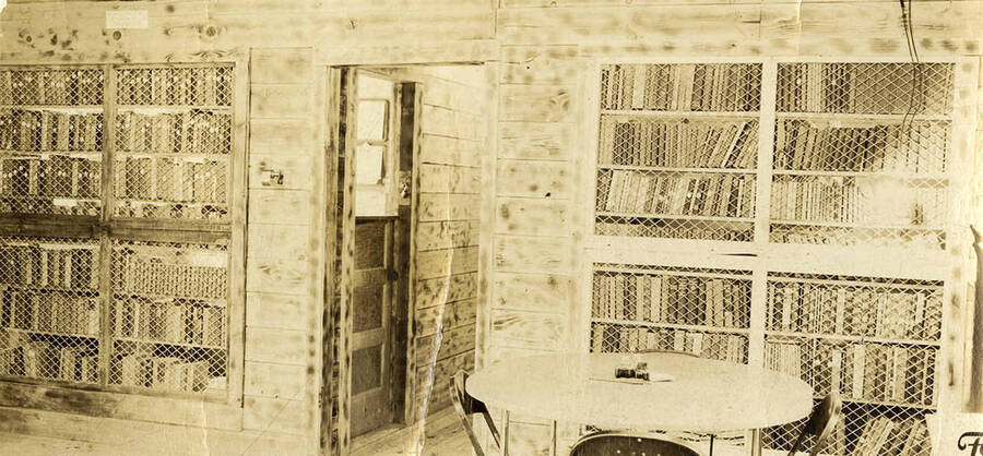 Interior view of the Big Creek 2 CCC Camp Education Building. Writing on the photo reads: 'Education Building CCC Company 531 Prichard, Idaho December 1938'.
