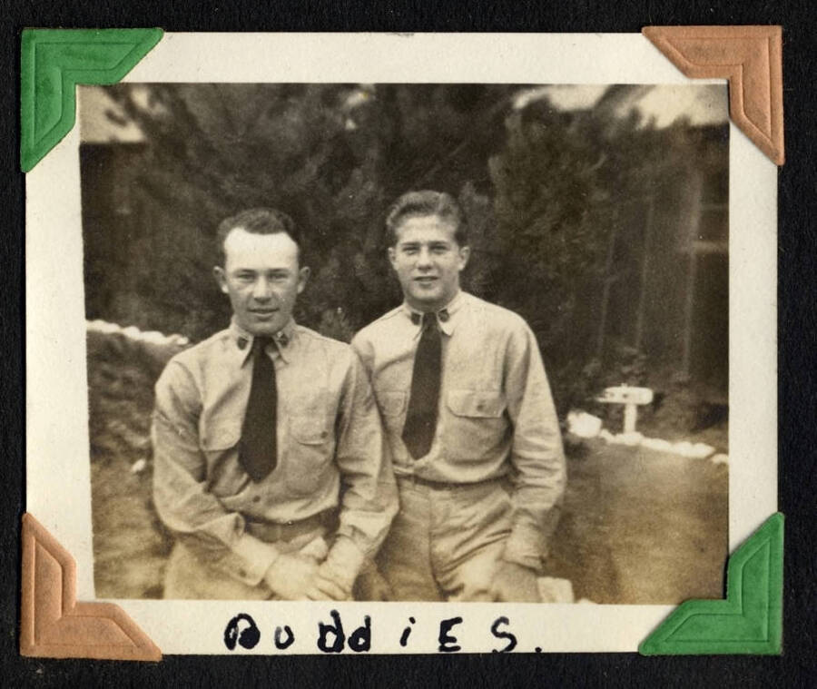 Two men in officer uniforms, captioned 'Buddies'. SCS-1, C-1503. From the Paul Saft photographic album, SCS-1, C-1503, 1938-39, depicting camp life, taken mostly in the Moscow, Lewiston, Robinson Lake areas.