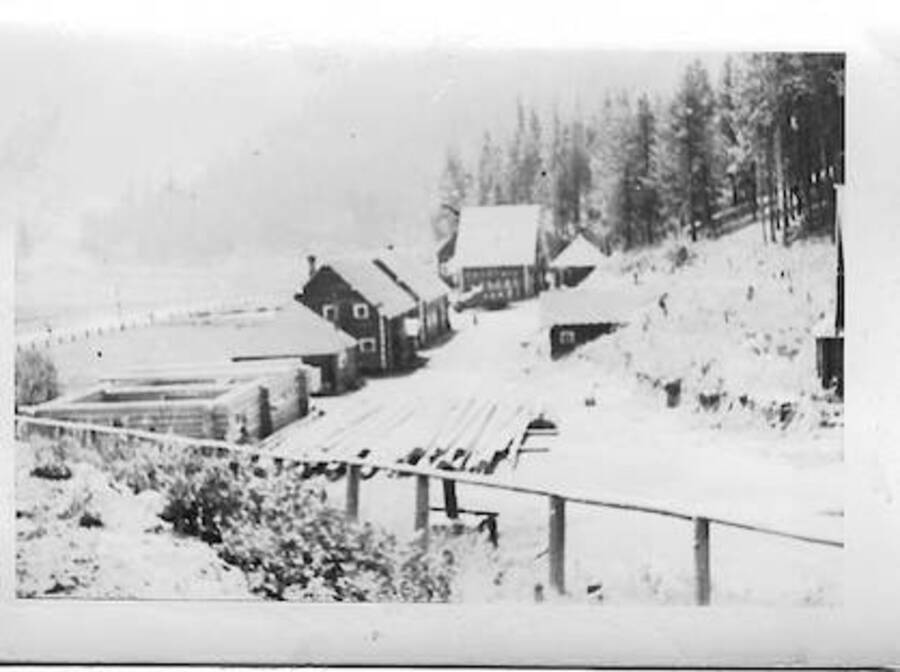 Camp view, Smith Ferry, 1939, view toward south. Mess hall and bunk house on second floor is tall far building. Camp superintendent house is visible.