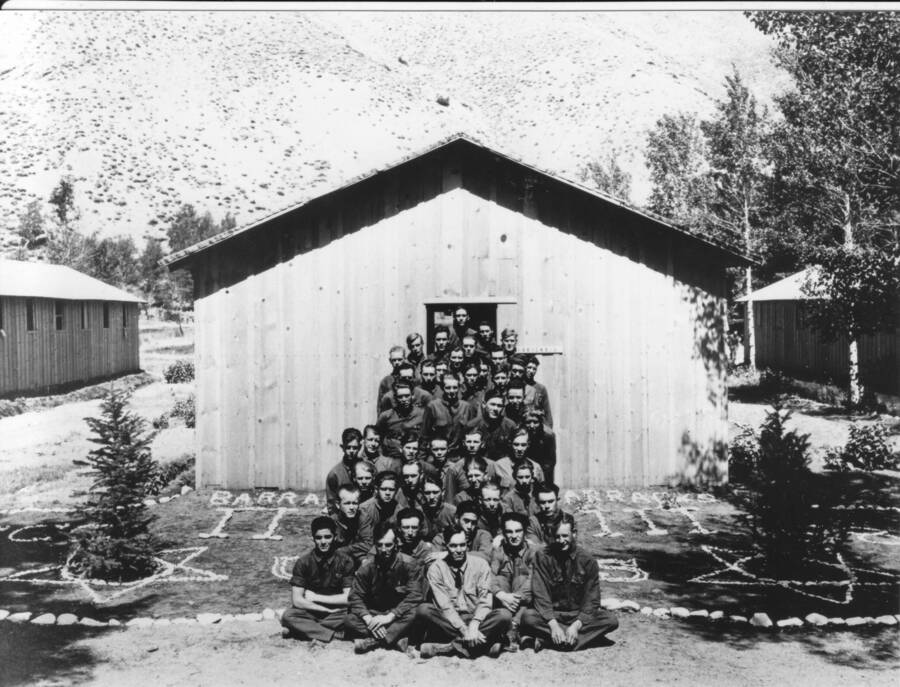 Formal group portrait taken at the end of long barrack, Ketchum, Sawtooth National Forest