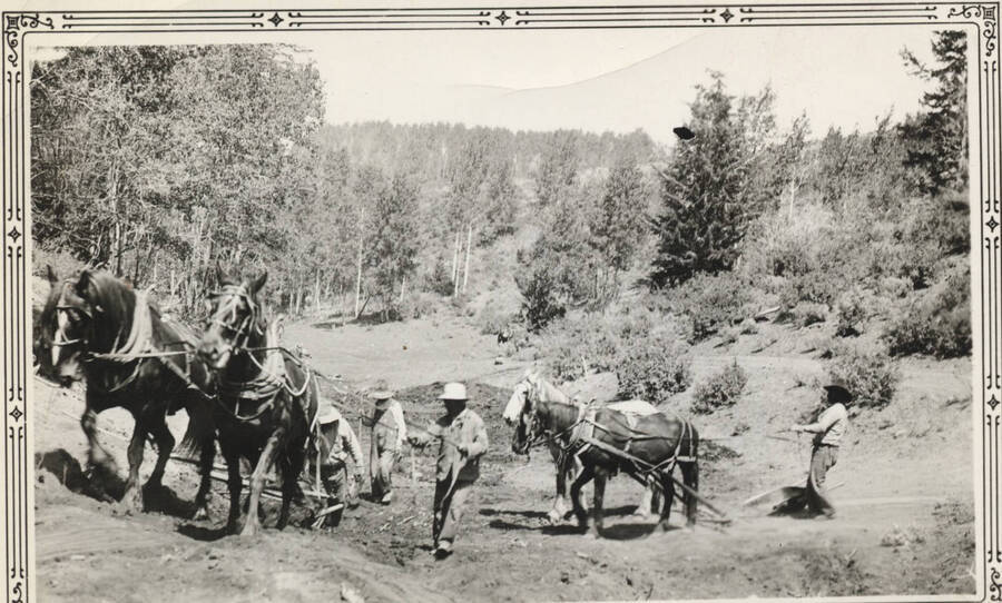 Two men with four-horse, two man plow, clearing a road, Fort Hall camp