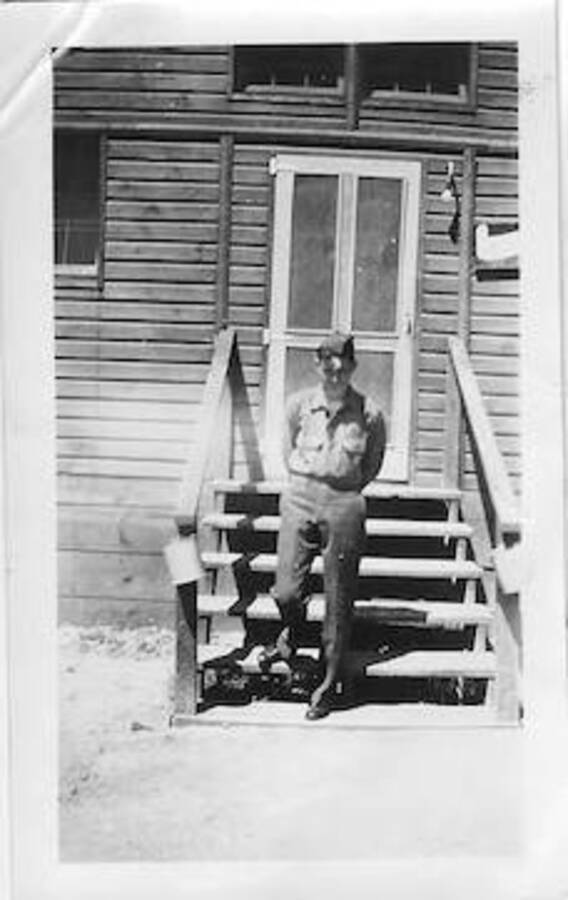 Man standing in front of building, captioned: 'W. Wallingford'. Camp Smith Ferry, 1939.