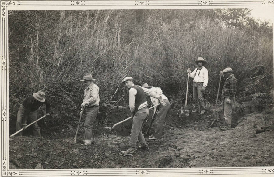 Work crew with shovels, clearing road through brush, Ft. Hall