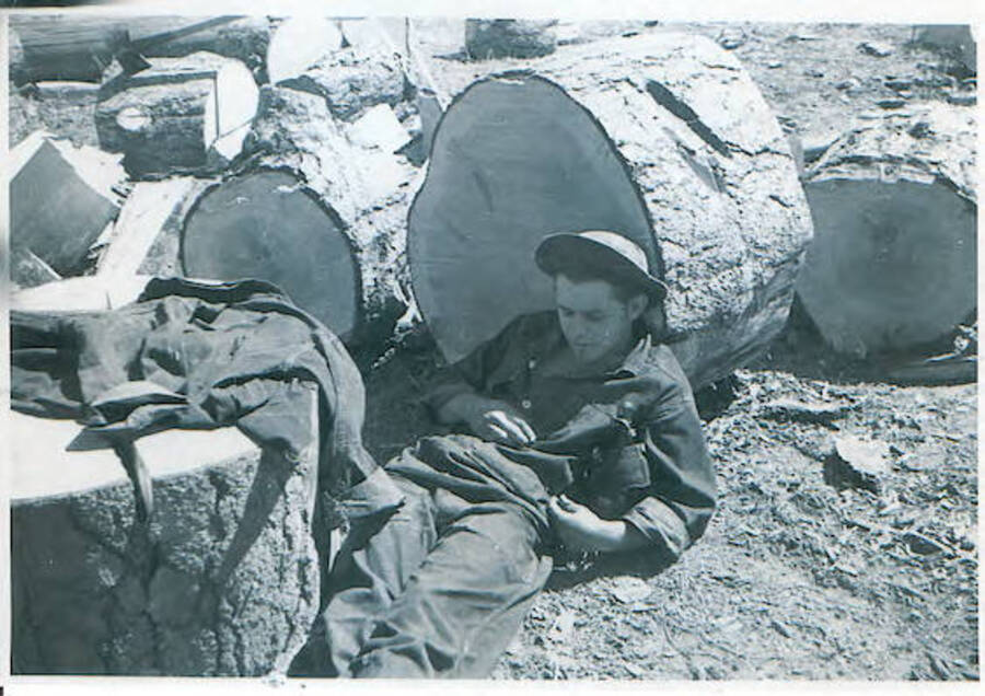 John Rais, Cincinatti, Ohio. Resting against cut log. Camp Smith Ferry, 1939.