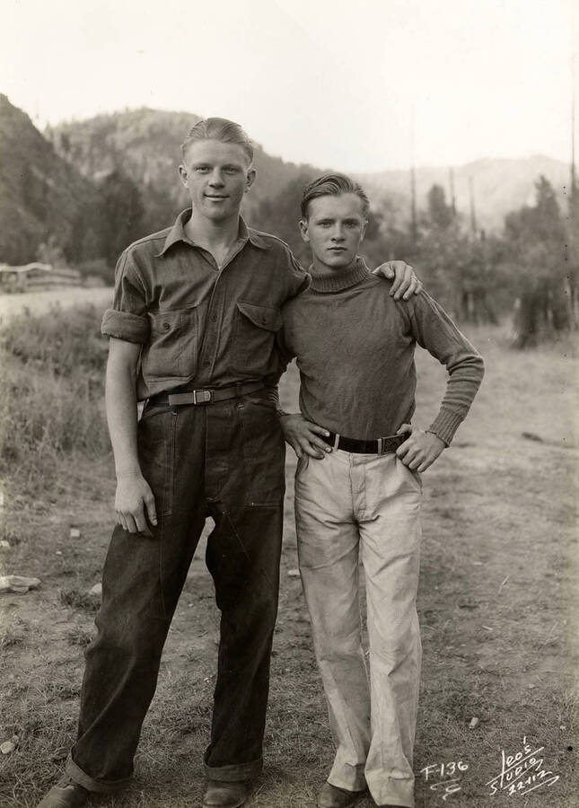 Two CCC men posing for a picture at the Grizzly Ranger Station CCC Camp F-136. Writing on the photo reads: 'F-136 Leo's Studio'.