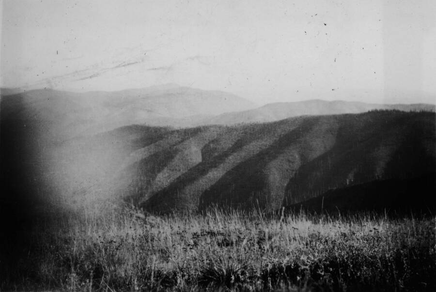 View of mountains. Ina Quist Davis identifies the picture as, "Looking over some mountains from a road by Beaver Patrol Station."