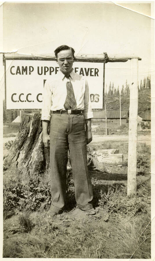 Man stands in front of Camp sign