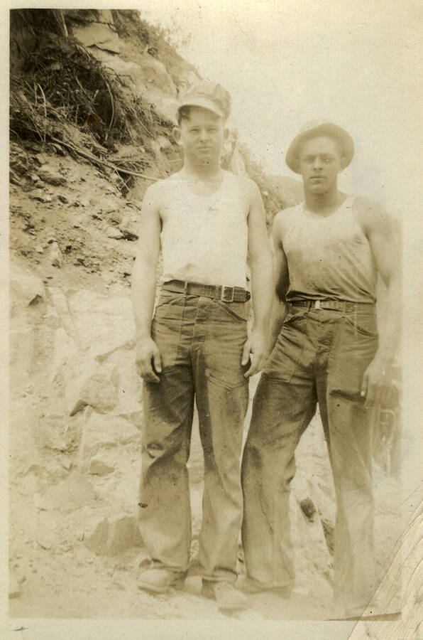 Ross (left) and Arnold D Bates (right) pose for a photograph. Back of photograph reads, "Ross + me"