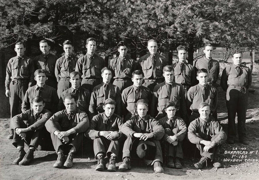 Group portrait of CCC men at Hayden Creek CCC Camp. Writing on the photo reads: 'Barracks # 1 F-180 Hayden Creek'.