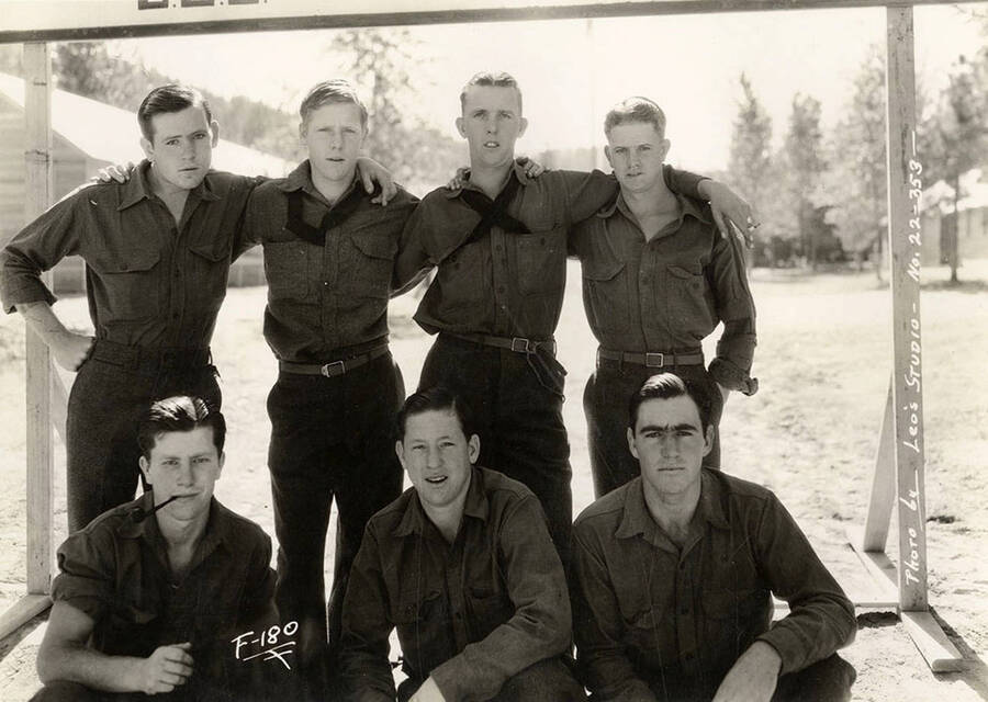 Group portrait of CCC men at Hayden Creek CCC Camp. Writing on the photo reads: 'F-180 photo by Leo's Studio'.