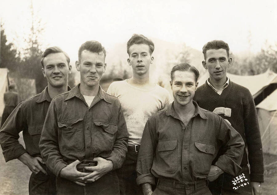 Group portrait of five CCC men at Hayden Creek CCC Camp. Writing on the photo reads: 'Leo's Studio'.