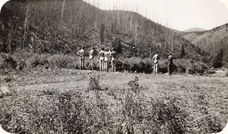 Group of CCC boys swimming in Teepee Creek without any swimming trunks. Back of photo reads: 'Swimming in Teepee Creek above Headwaters of Coeur d'Alene River - Magee - 1935'.