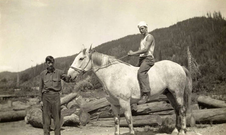 Two CCC men posed with a horse (which is presumably called Barney) Note the rider is wearing a cook's cap. Back of photo reads: '1935 Barney'.