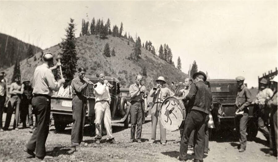 CCC men assembled with their instruments at Magee View looking toward the Ranger Station. Back of photo reads: 'Music at Magee 1935 View looking toward Ranger Station Magee (?) jay Band 1935'.