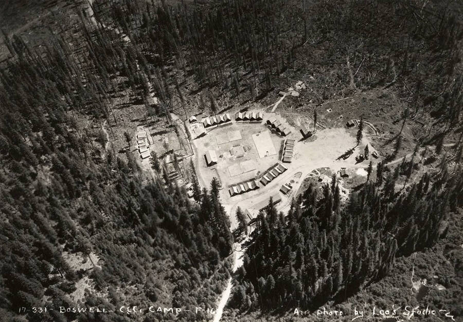 Aerial view of Boswell CCC Camp, F-163. Writing on the photo reads: 'Boswell CCC Camp F-163 Air photo by Leo's Studio'. Back of photo reads: 'Boswell Camp Priest River'.