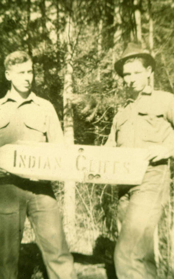 CCC men who had built a the trail, hold the sign for Indian Cliffs. The sign reads 'Indian Cliffs.'