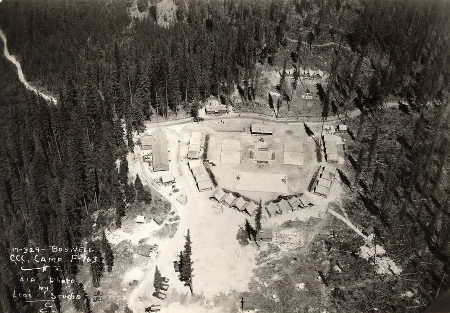 Aerial view of Boswell CCC Camp, F-163. Note geoglyph in the top right hand corner of the photo, it reads: 'F-163'. Writing on the photo reads: 'Boswell CCC Camp F-163 Air photo by Leo's Studio'.