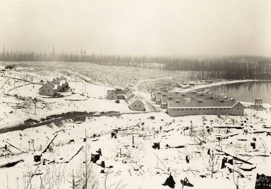 View of Kalispell Bay CCC Camp, F-142 in winter. Writing on the photo reads 'Leo's Studio'. Back of photo reads: 'Kalispell Bay'.
