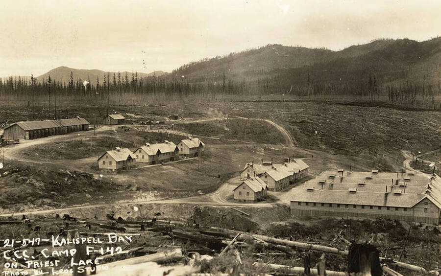 View of Kalispell Bay CCC Camp, F-142. Writing on the photo reads: 'Kalispell Bay CCC Camp F-142 on Priest Lake Photo by Leo's Studio'.