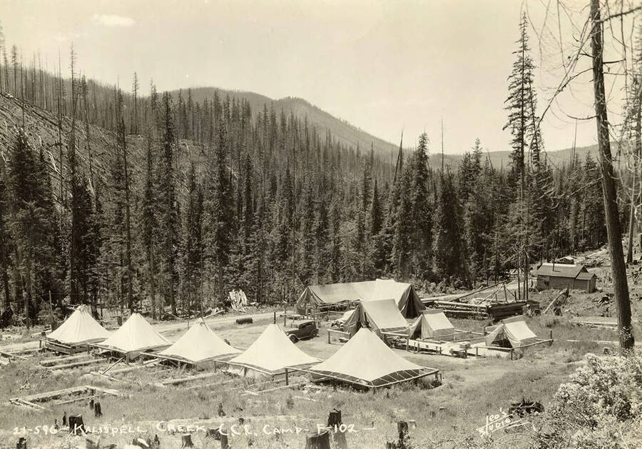 View of Kalispell Creek CCC Camp, F-102,  under construction. Writing on the photo reads: 'Kalispell Creek CCC Camp F-102. Leo's Studio'.