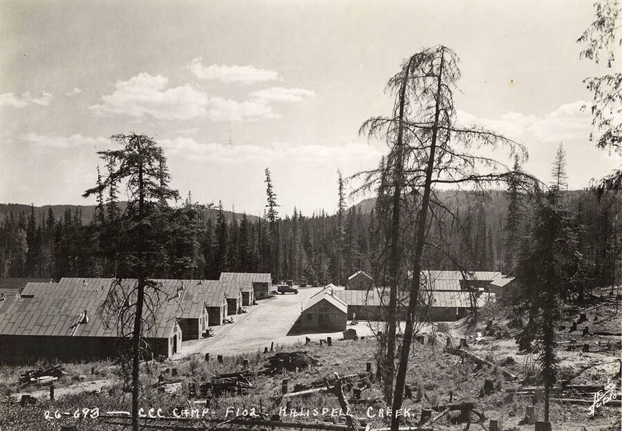 View of Kalispell Creek CCC Camp, F-102. Writing on the photo reads: 'CCC Camp F-102. Kalispell Creek. Leo's Studio'. Back of photo reads: 'Kanisku'.