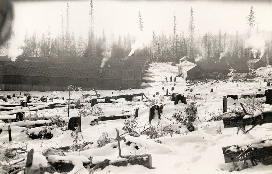 View of Kalispell Creek Camp, F-102, in the winter. Writing on the photo reads: 'F-102 Leo's Studio'. Back of photo reads: 'Kanisku'.