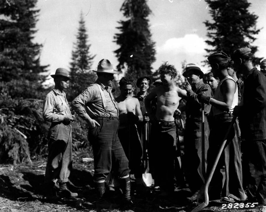 Ranger McKay talking to the CCC boys from Packer Meadows Camp F-23, Selway National Forest, Idaho. Photo taken in September.