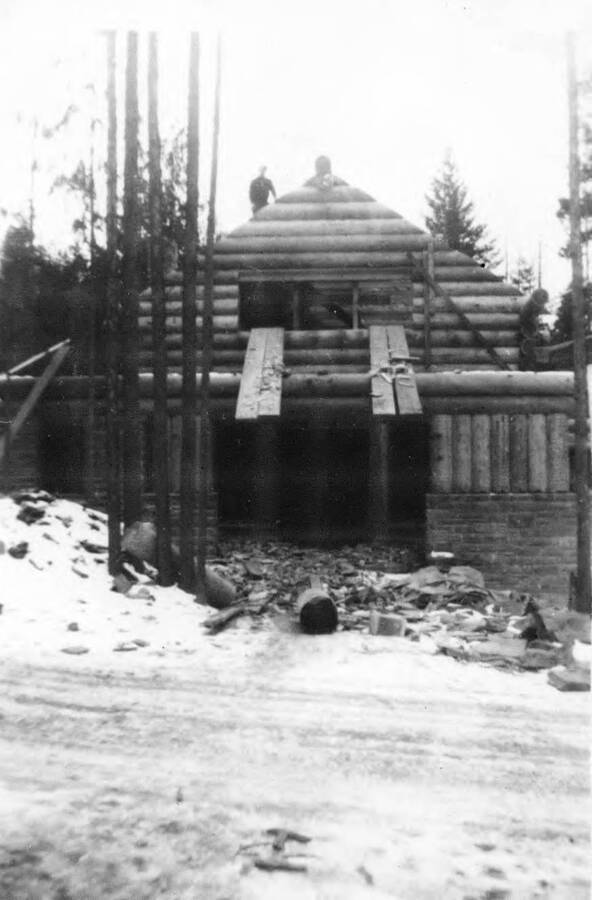 Lodge under construction at Heyburn State Park.  A man poses on the roof.