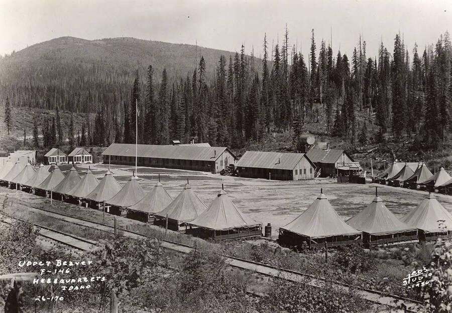 View of Upper Beaver CCC Camp and the surrounding area. Writing on the photo reads: 'Upper Beaver F-146 Headquarters, Idaho Leo's Studio 1936'.