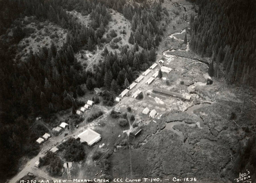 Aerial view of Merry Creek CCC Camp, F-140. Note the geoglyph that reads 'F-140'. Writing on the photo reads: 'Air view Merry Creek CCC Camp F-140 Company 1236 Leo's Studio'. Back of photo reads: 'St. Joe'.
